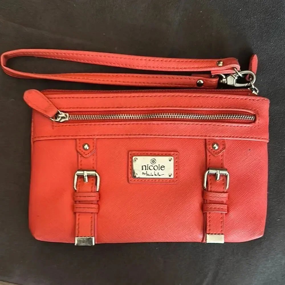 Nicole by Nicole Miller salmon colored Wristlet with Gold Details
